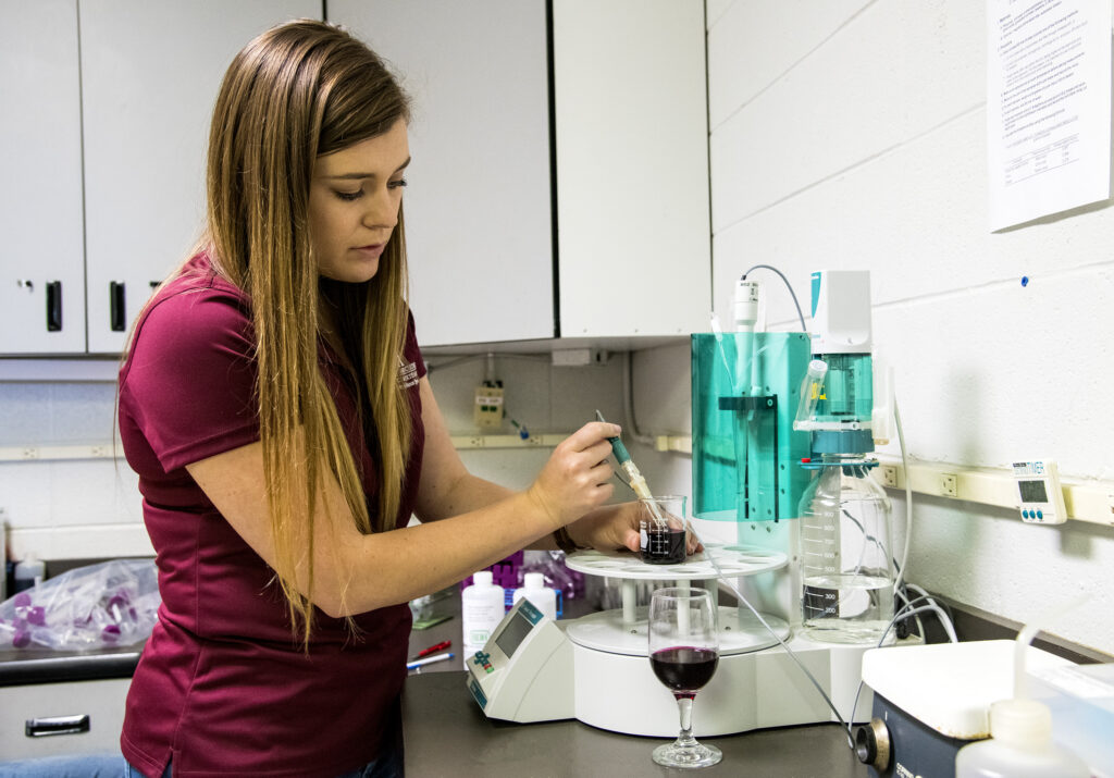 Graduate student Sarah Mayfield tests the pH of wine samples from Division of Agriculture wine grapes. Mayfield received an ASEV scholarship for her graduate research in enology — the study of wine production.